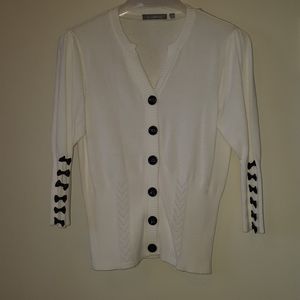 White cardigan with black buttons and black bows